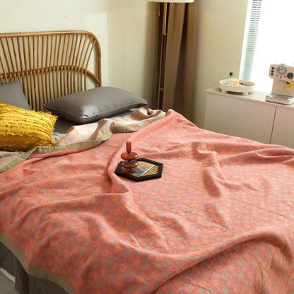 Wendbare Steppdecke aus Baumwolle mit buntem Gänseblümchenmuster