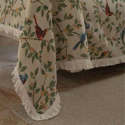 Weicher Sofaschoner mit Quasten und Blumen- und Vogelmotiv