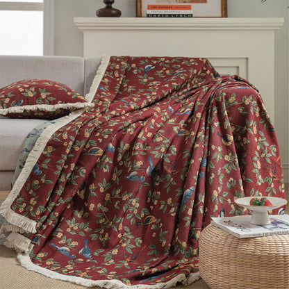 Weicher Sofaschoner mit Quasten und Blumen- und Vogelmotiv