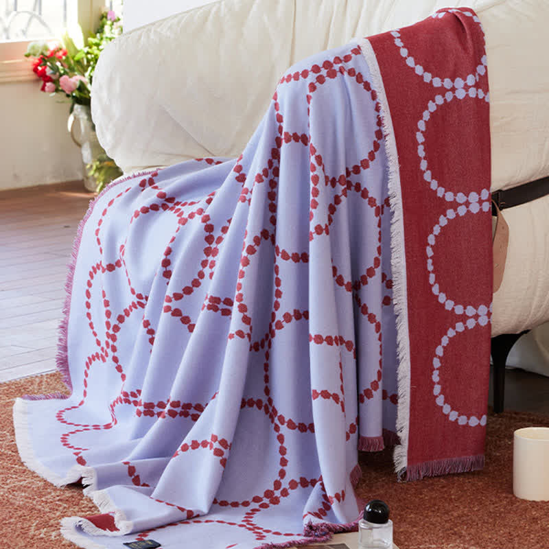 Wendbare Kuscheldecke mit Kreismuster und Quasten - image 1