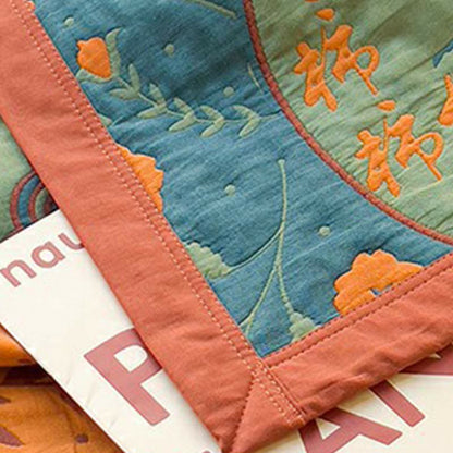 Doppelseitige Steppdecke aus Baumwolle mit Persimmon-Blumenmotiv